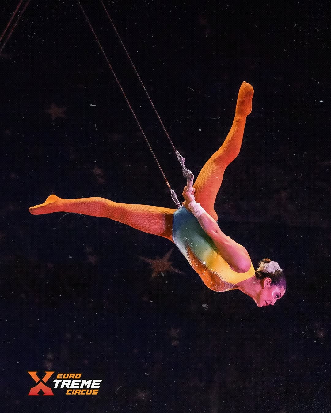 Aerial circus performer suspended above the stage