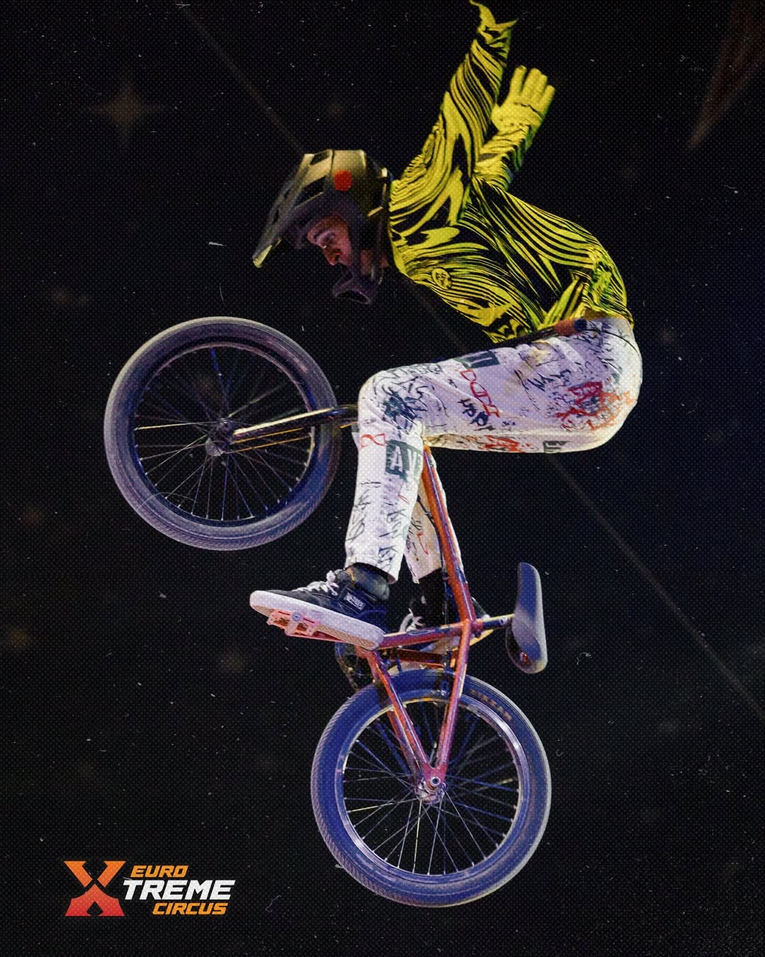 BMX rider performing a stunt on stage